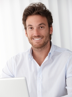 A man with bright, white teeth smiling