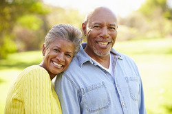 An older couple with healthy and complete smiles